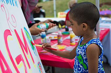 Child painting at Pride Event